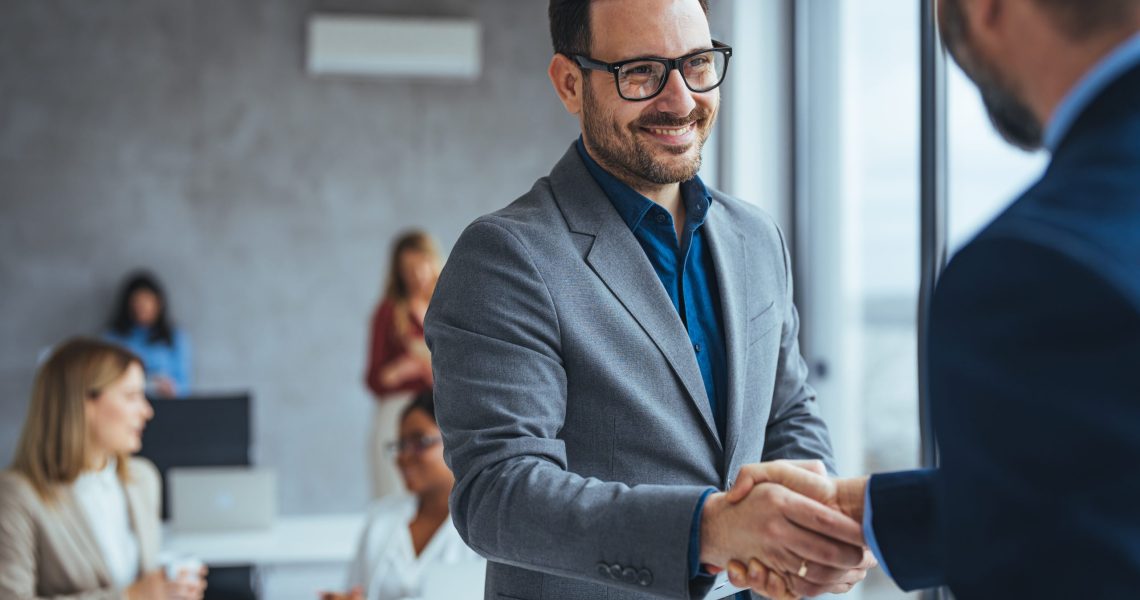 Portrait,Of,Cheerful,Young,Manager,Handshake,With,New,Employee.,Business