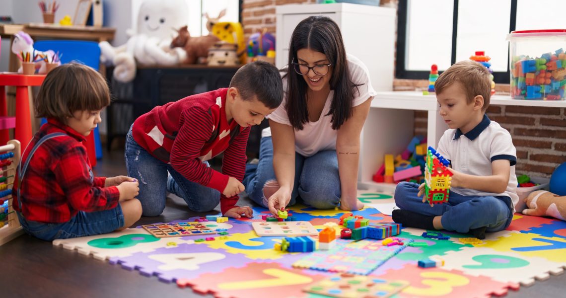 Teacher,With,Group,Of,Boys,Playing,With,Maths,Puzzle,Game