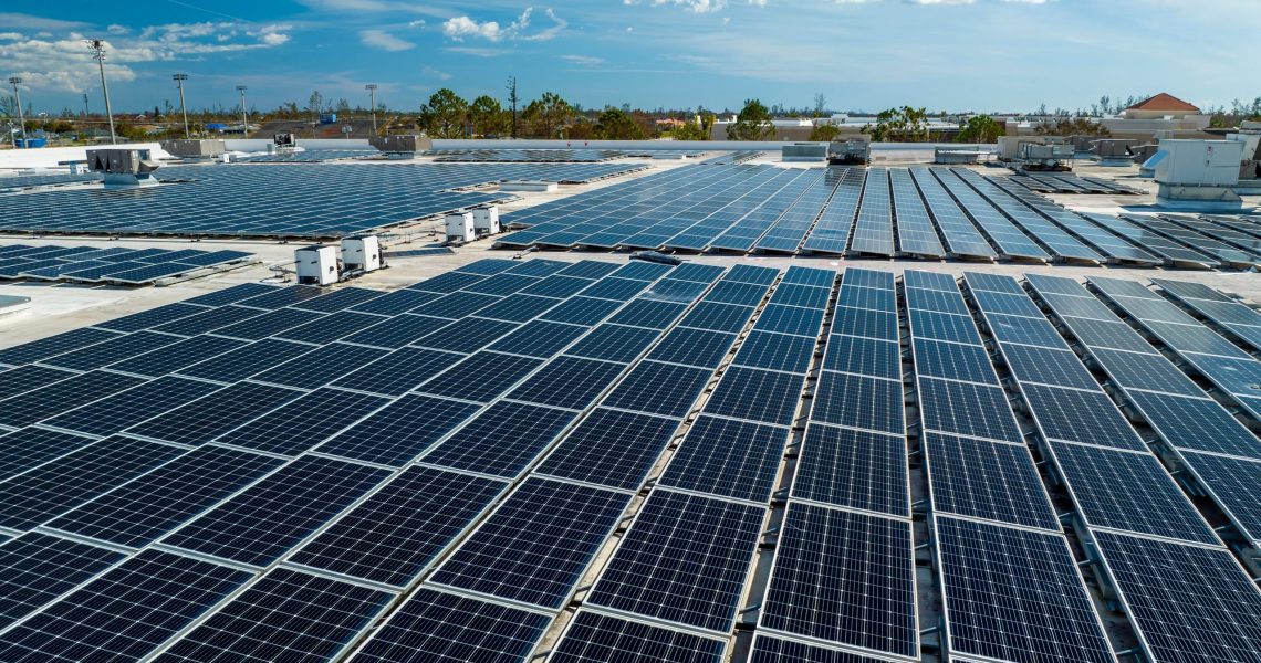 Aerial,View,Of,Blue,Photovoltaic,Solar,Panels,Mounted,On,Industrial