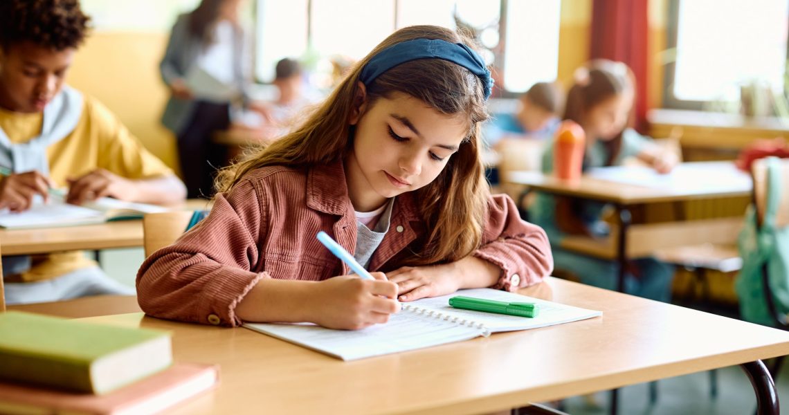 Schoolgirl,Writing,While,Learning,During,A,Class,In,The,Classroom.
