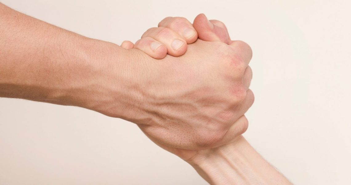 Two,Hands,Hold,Tightly,To,Each,Other,,Rescuer,Saves,,Pulls