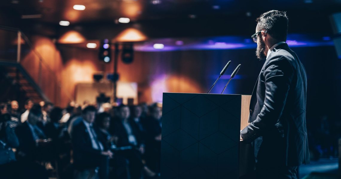 Speaker,Giving,A,Talk,On,Corporate,Business,Conference.,Unrecognizable,People