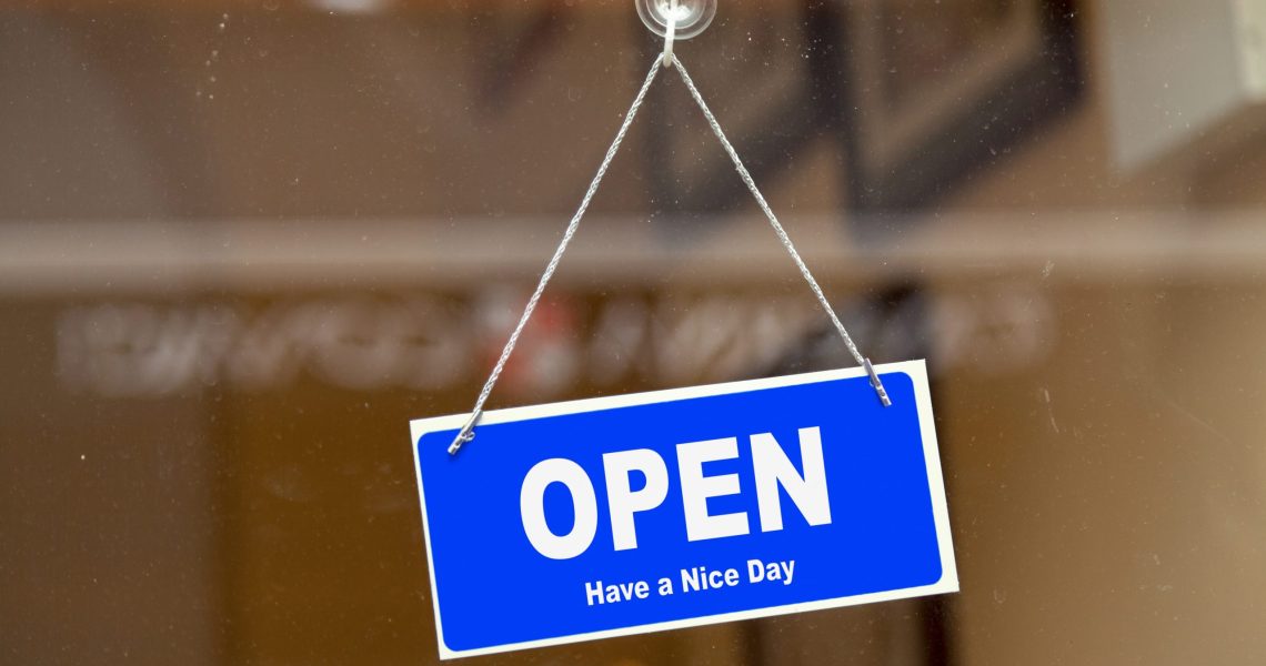 Blue,Sign,Open,Sign,Anging,At,The,Glass,Door,Of