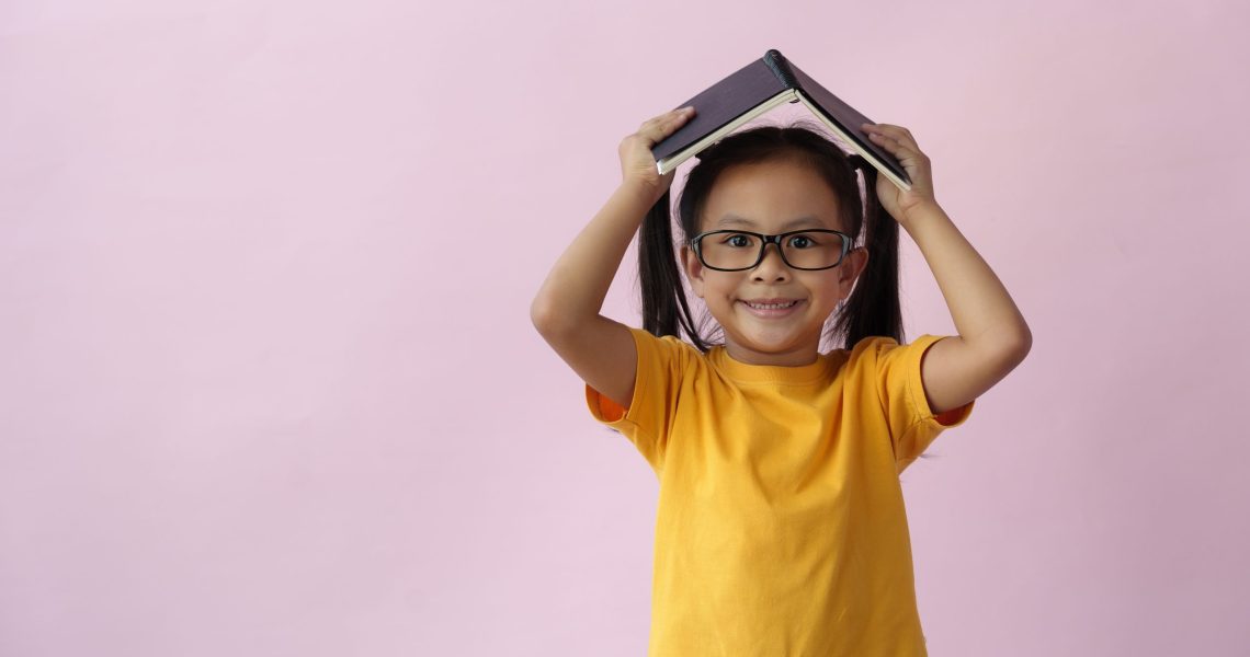 Child,Wearing,Glasses,Holding,A,Notebook,Note,Paper,In,A