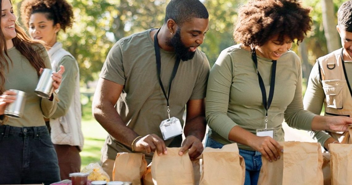 Happy,People,,Volunteer,And,Packing,With,Bags,For,Charity,,Food