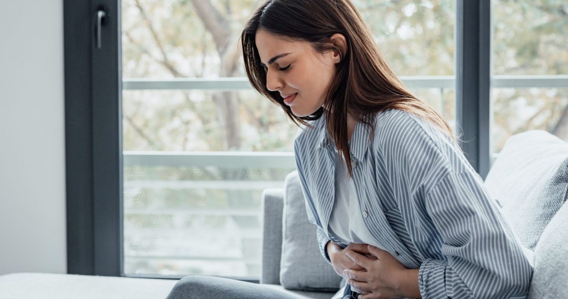 Sick,Young,Woman,In,Pain,Holding,Belly,Stomach,Feeling,Hurt