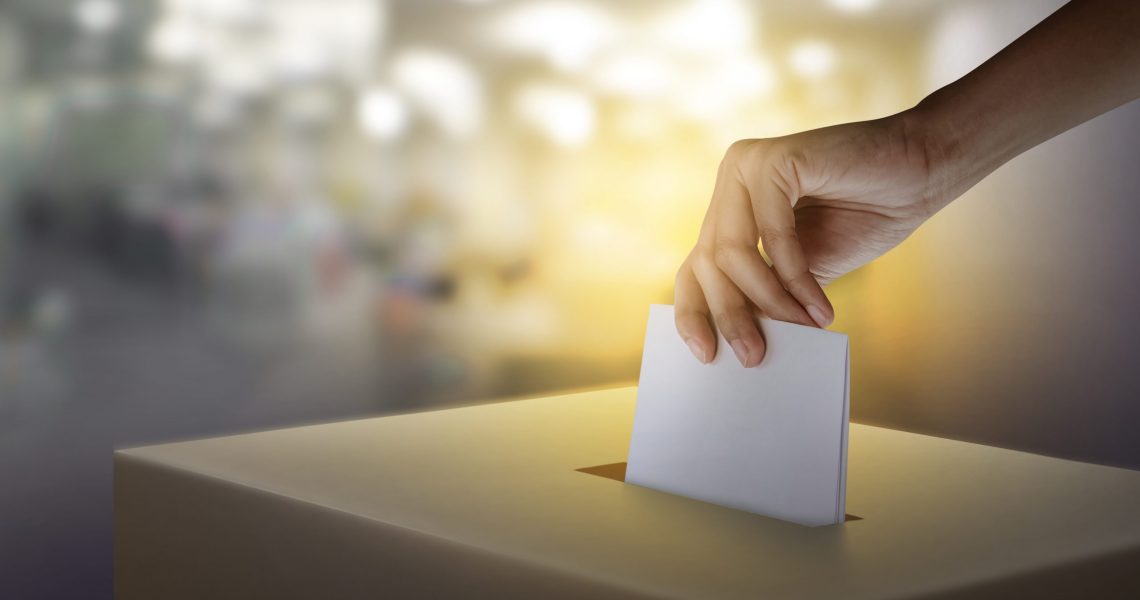 Woman,Hand,Throws,Voting,Ballot,Paper,In,Ballot,Box,,Concept