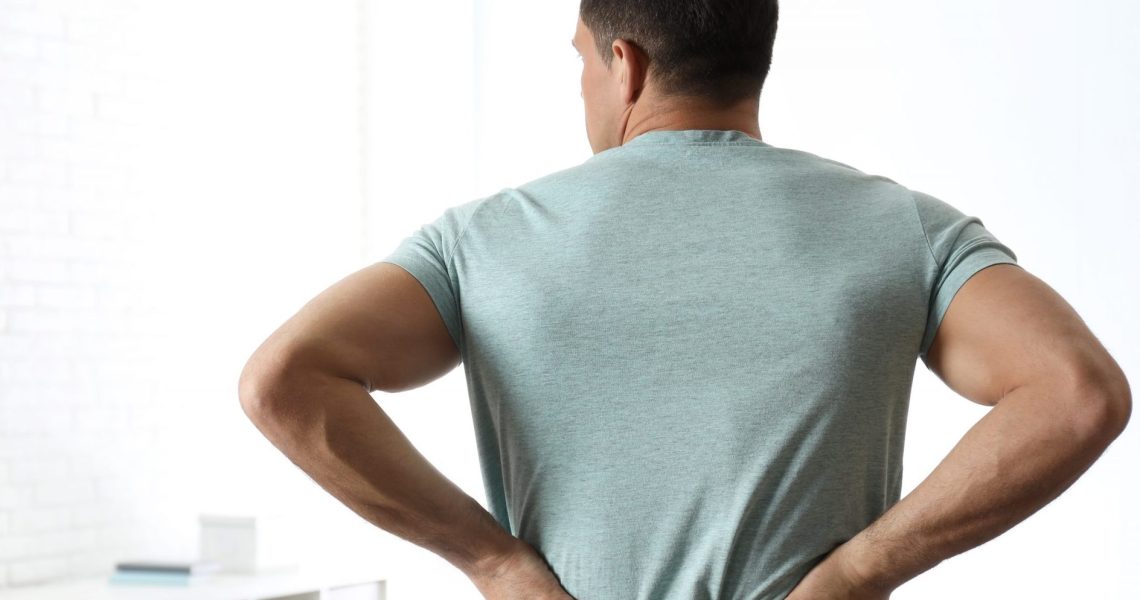 Man,Suffering,From,Lower,Back,Pain,At,Clinic.,Visiting,Orthopedist